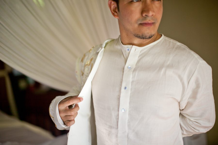Bunn Salarzon - indonesian groom putting on jacket