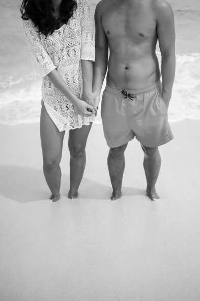 Bunn Salarzon - woman and man holding hands on sandy beach